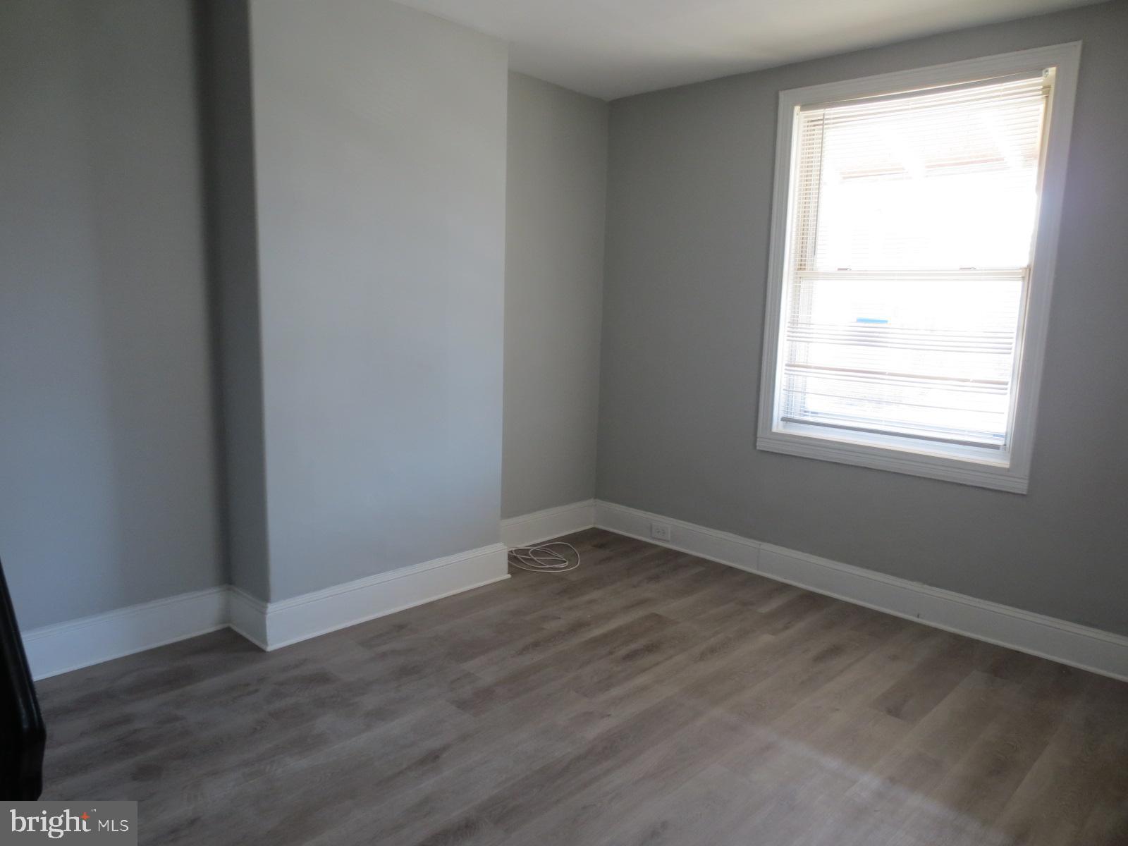 617 Benson Street Philadelphia, PA 19111 - Photo 18 of 37 an empty room with wooden floor and windows