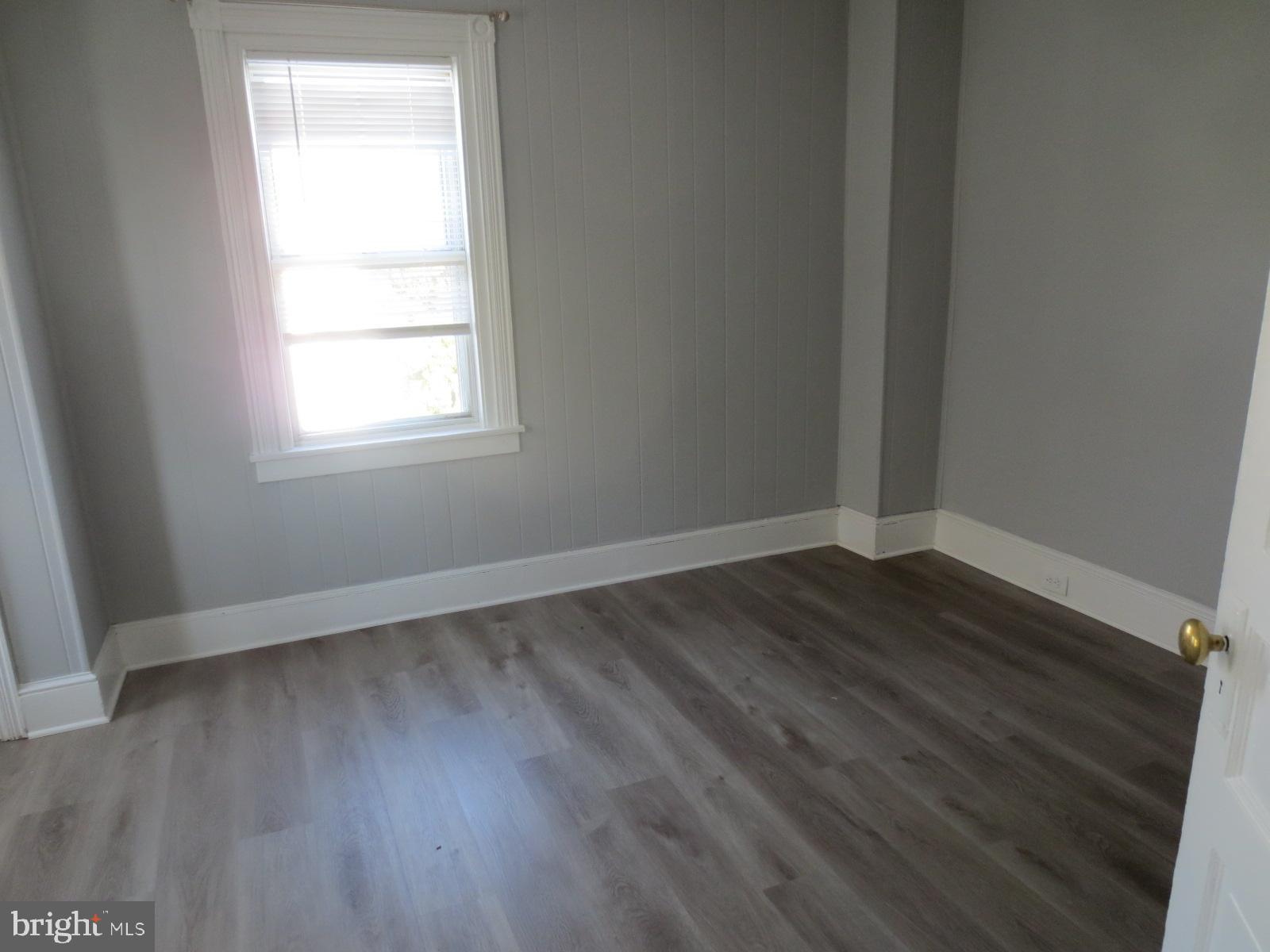 617 Benson Street Philadelphia, PA 19111 - Photo 23 of 37 an empty room with wooden floor and windows