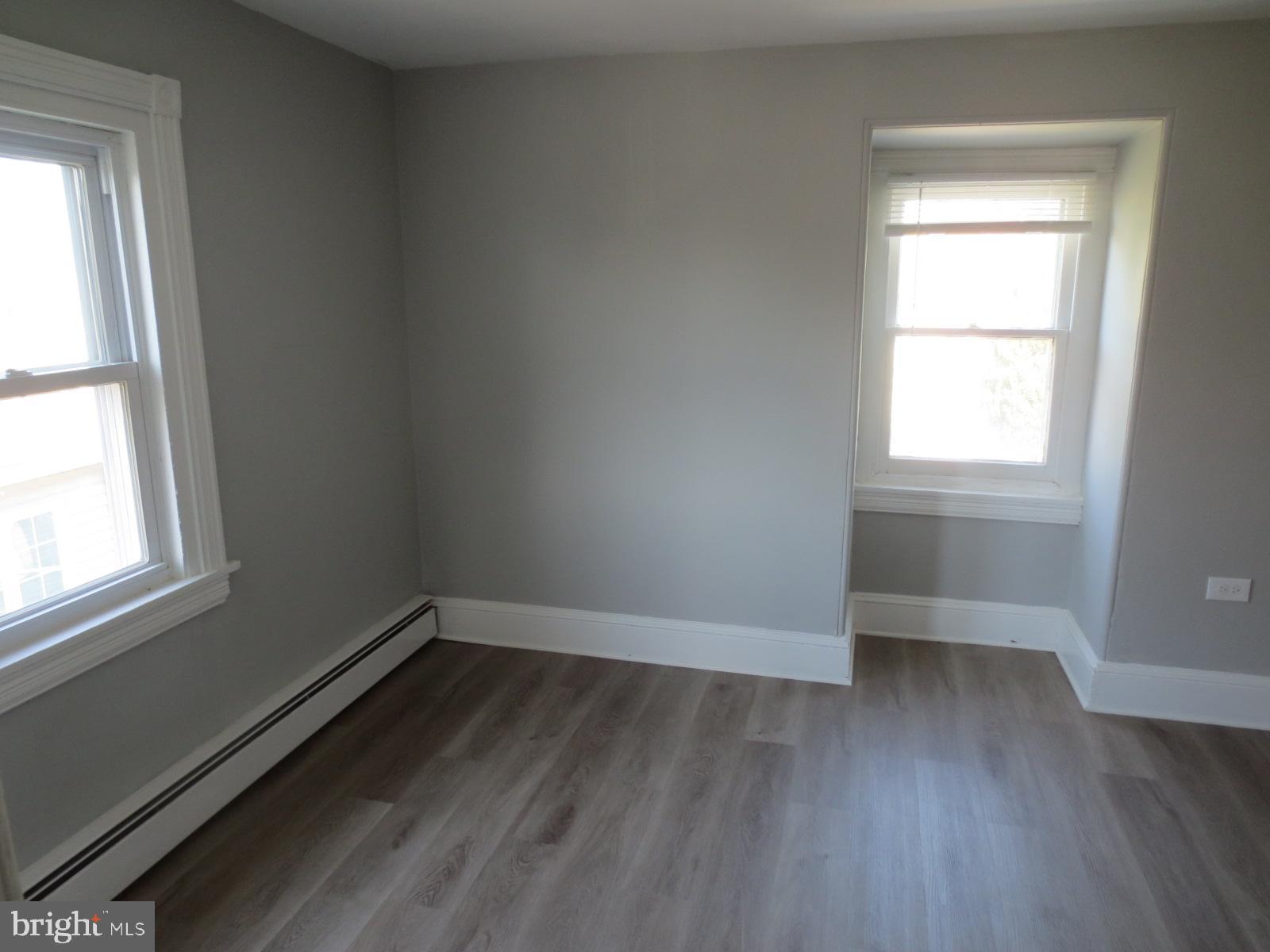 617 Benson Street Philadelphia, PA 19111 - Photo 28 of 37 an empty room with wooden floor and windows
