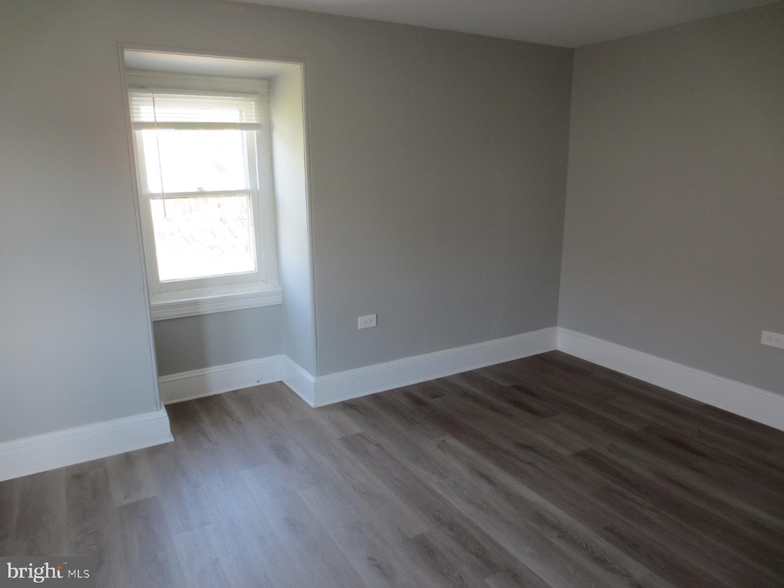 617 Benson Street Philadelphia, PA 19111 - Photo 29 of 37 an empty room with wooden floor and windows