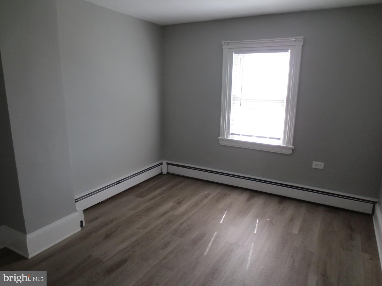 617 Benson Street Philadelphia, PA 19111 - Photo 32 of 37 an empty room with wooden floor and windows