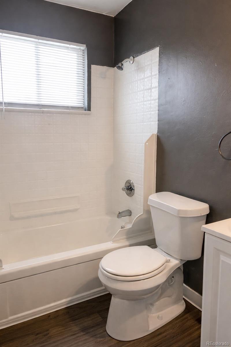 7155 Stuart Street Westminster, CO 80030 - Photo 4 of 11 a white toilet and tub next to a window
