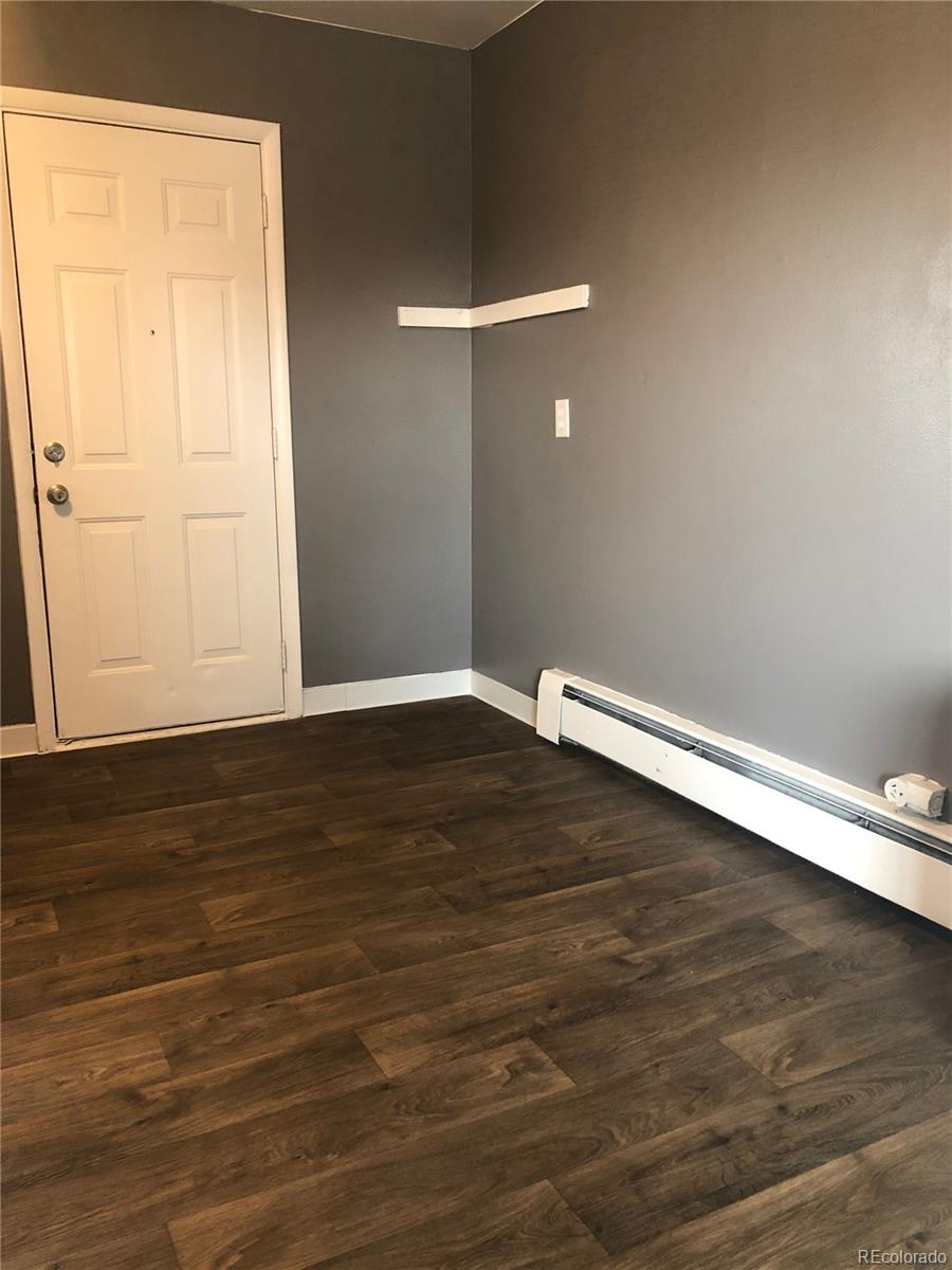 7155 Stuart Street Westminster, CO 80030 - Photo 7 of 11 an empty room with wooden floor and windows