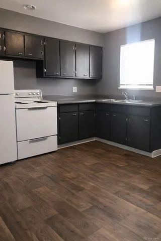 a kitchen with a sink a stove and cabinets