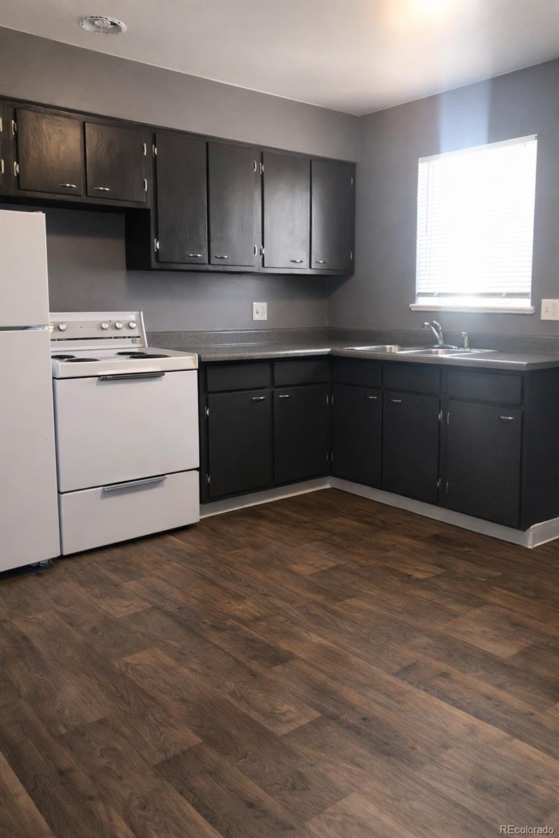 7155 Stuart Street Westminster, CO 80030 - Photo 8 of 11 a kitchen with a sink a stove and cabinets