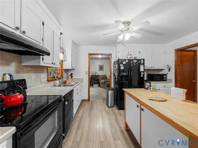 a kitchen with a stove a sink and a refrigerator