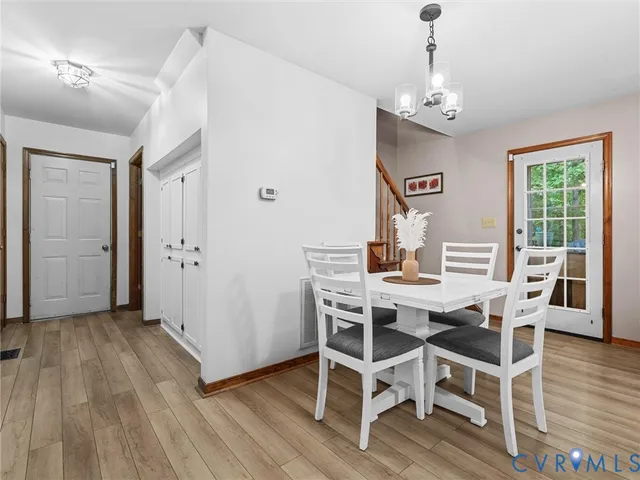 a view of a dining room with furniture wooden floor and chandelier