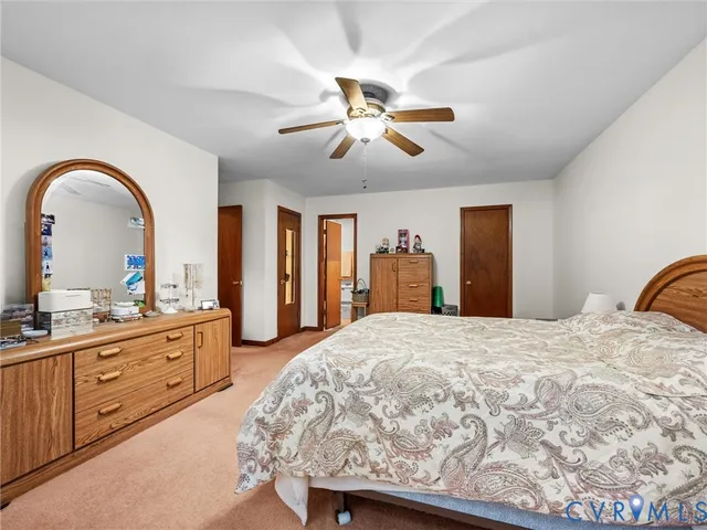 a spacious bedroom with a bed and a dresser