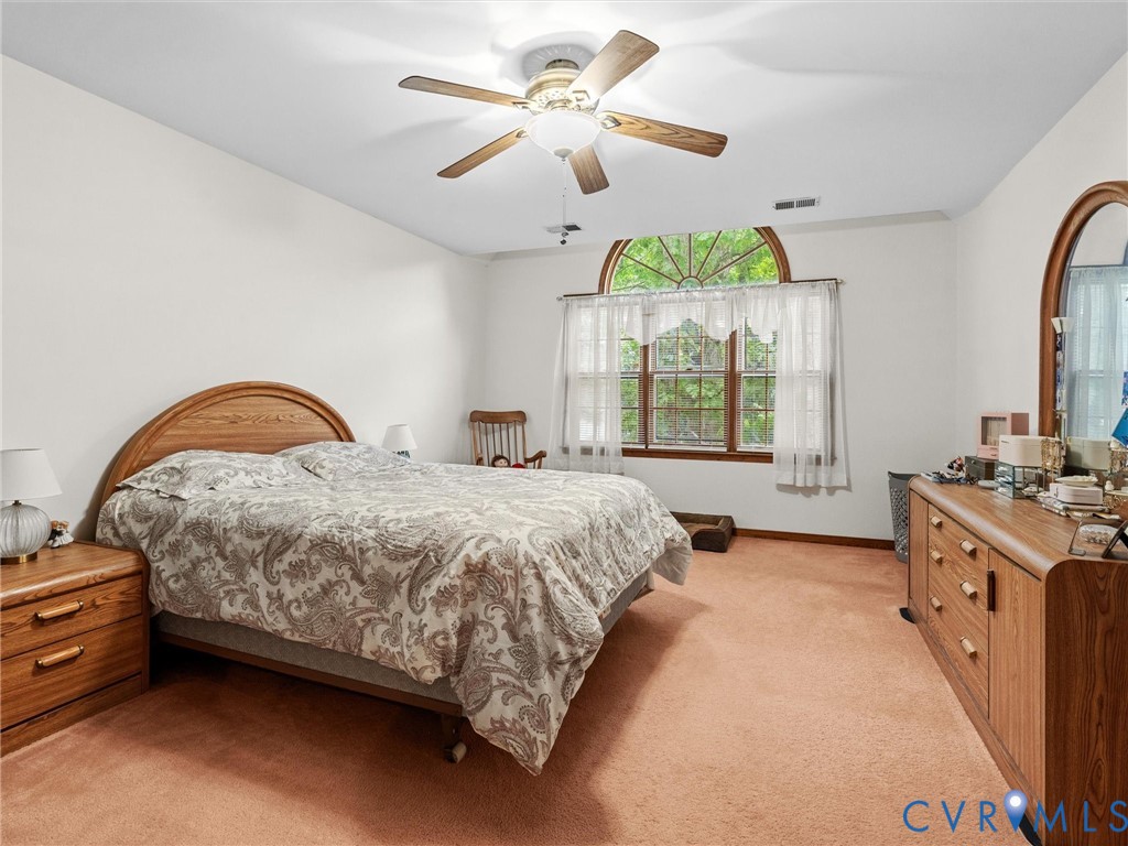 7706 Northern Dancer Court Midlothian, VA 23112 - Photo 18 of 40 a bedroom with a bed and a chandelier