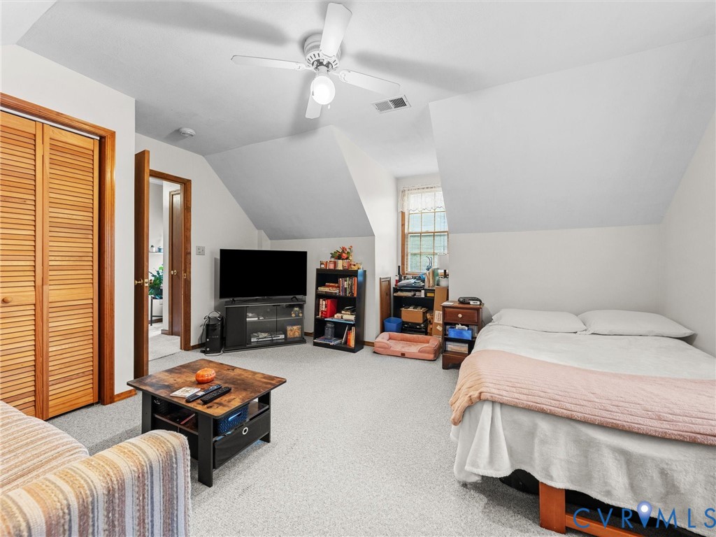 7706 Northern Dancer Court Midlothian, VA 23112 - Photo 22 of 40 a bedroom with bed and a flat tv screen on the dresser