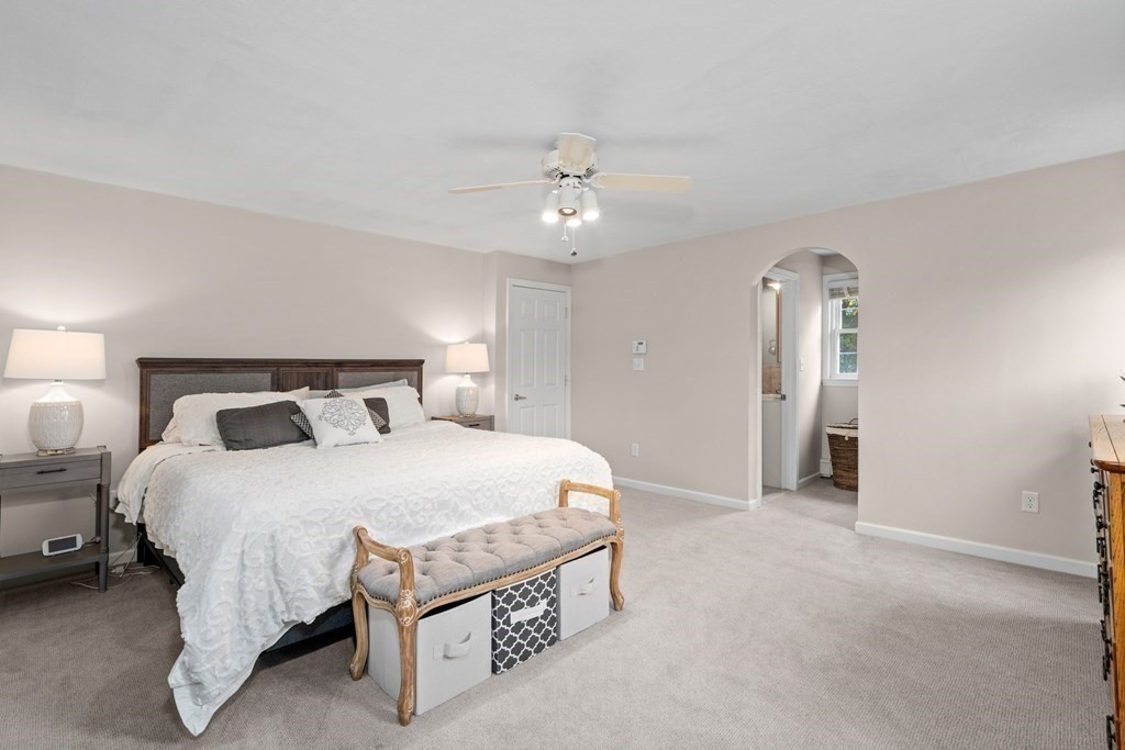 4 Robert Street Walpole, MA 02081 - Photo 14 of 37 a spacious bedroom with a bed and a chandelier
