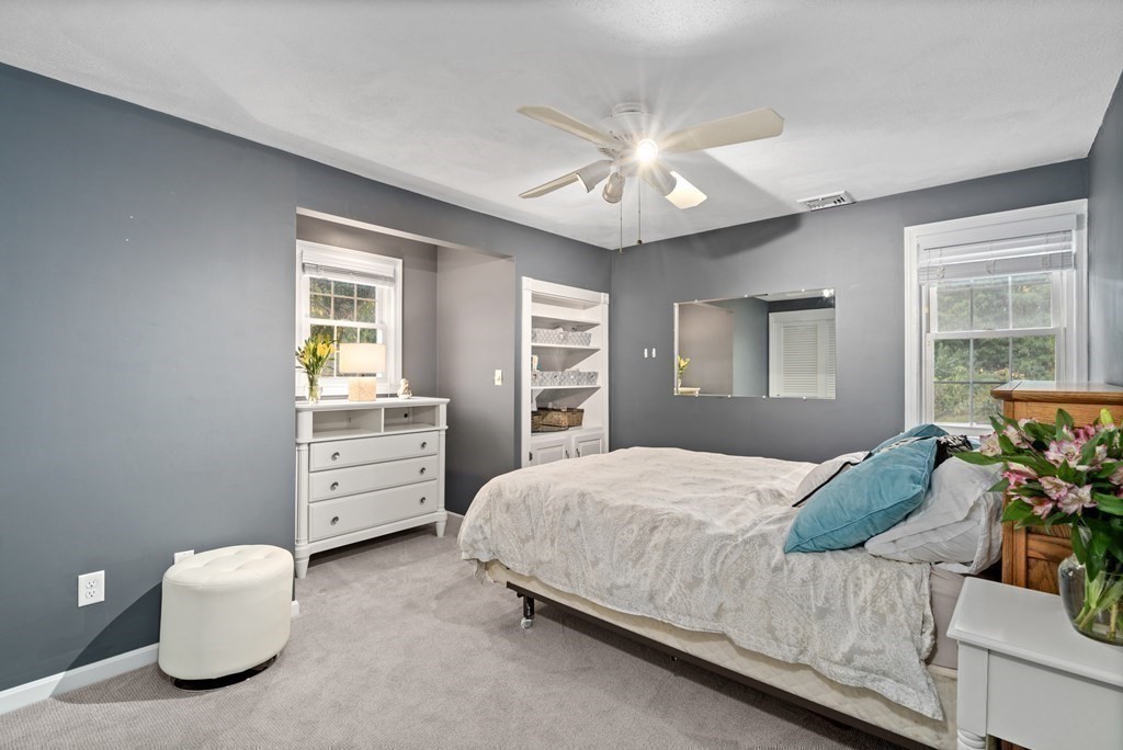 4 Robert Street Walpole, MA 02081 - Photo 20 of 37 a bedroom with a bed and a chandelier