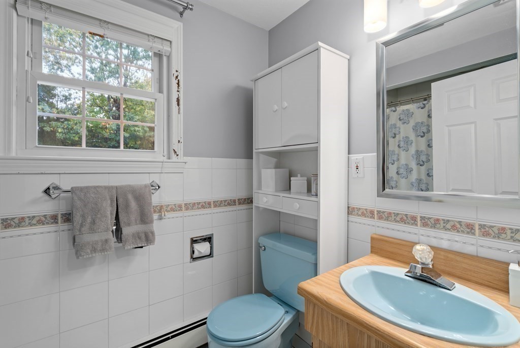 4 Robert Street Walpole, MA 02081 - Photo 23 of 37 a bathroom with a sink a toilet and a mirror