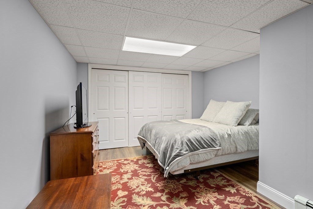 4 Robert Street Walpole, MA 02081 - Photo 26 of 37 a bedroom with a bed and wooden floor