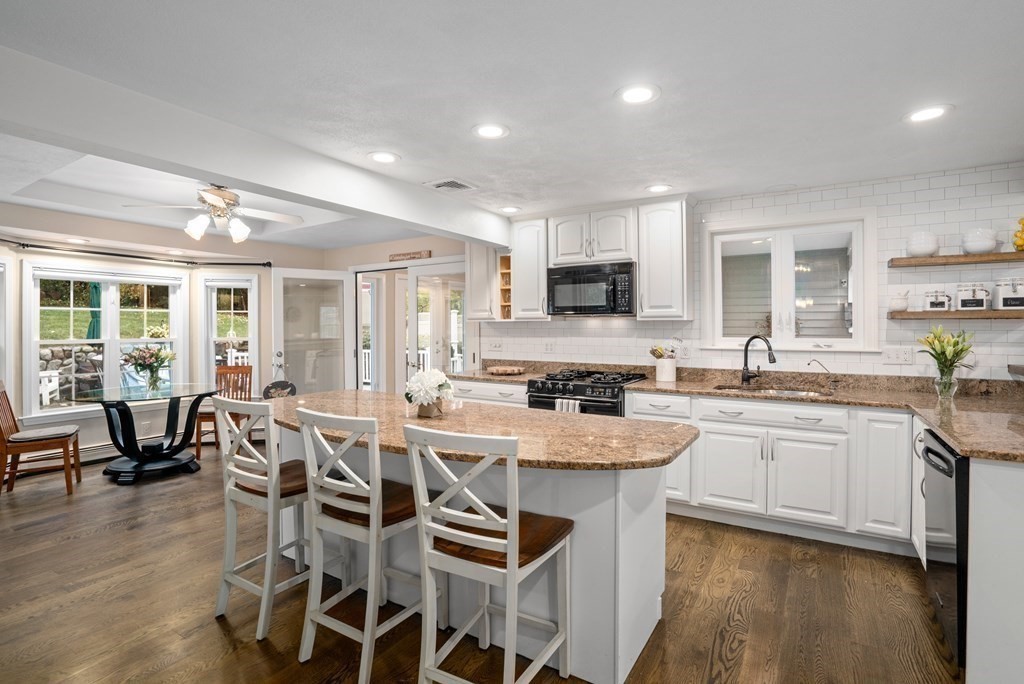 4 Robert Street Walpole, MA 02081 - Photo 3 of 37 a large kitchen with kitchen island granite countertop lots of white cabinets appliances and furniture