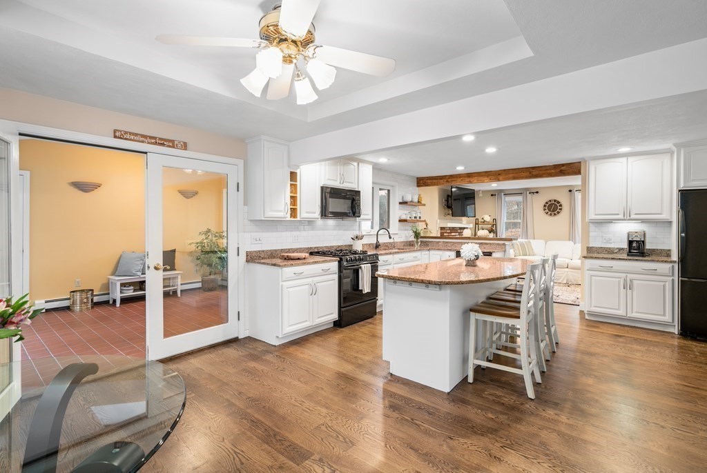 4 Robert Street Walpole, MA 02081 - Photo 5 of 37 a kitchen with a sink stove cabinets and chairs