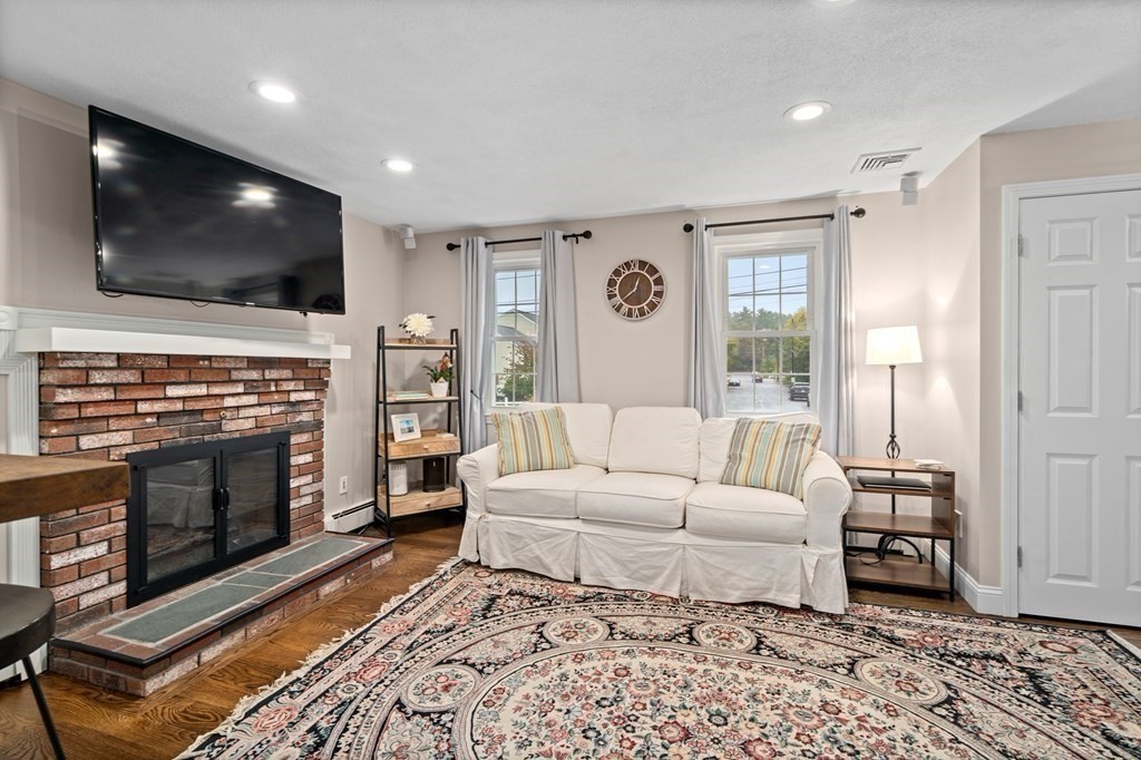 4 Robert Street Walpole, MA 02081 - Photo 8 of 37 a living room with fireplace furniture and a flat screen tv