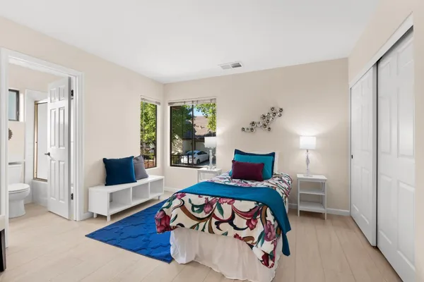 a bedroom with furniture and wooden floor