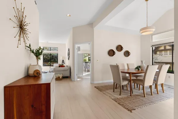 a view of a dining room with furniture and wooden floor
