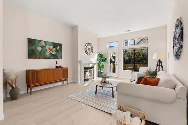 a living room with furniture a rug and a large window