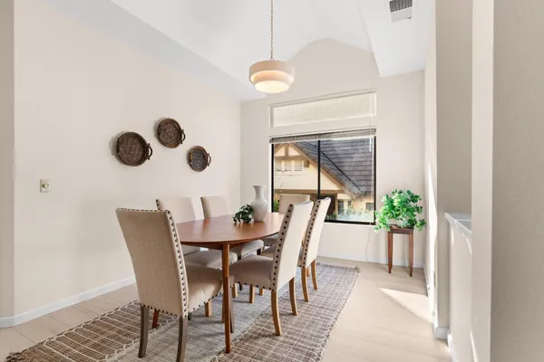 a view of a dining room with furniture and chandelier