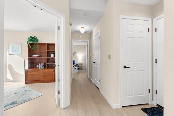 a view of a bathroom with a tub shower and hardwood floor
