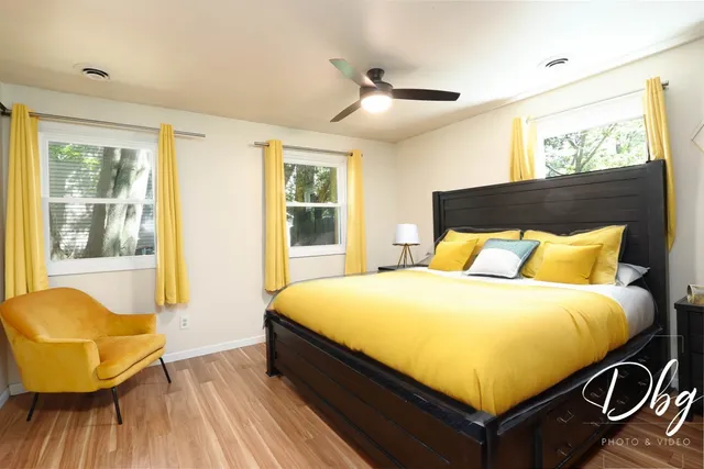 a bed sitting in a bedroom next to a window