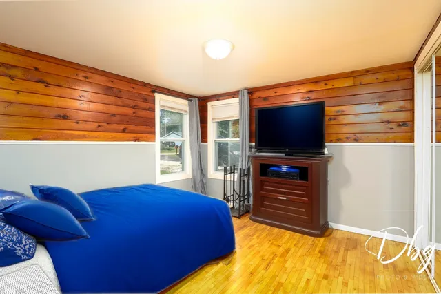 a bedroom with a bed and a flat screen tv