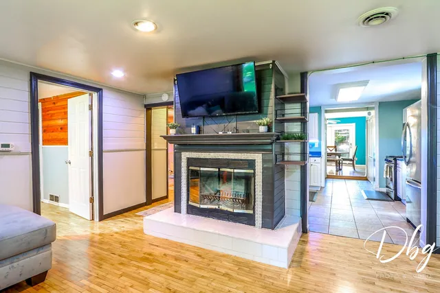 a living room with furniture a flat screen tv and a fireplace