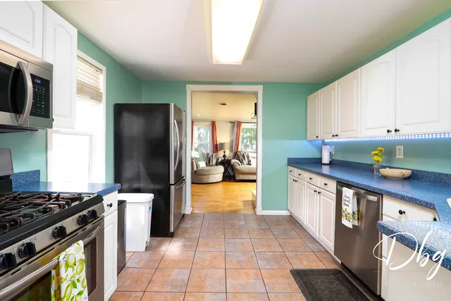 a kitchen with stainless steel appliances granite countertop a stove a sink and a refrigerator