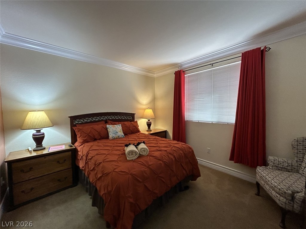 210 East Flamingo Road, Unit 137 Las Vegas, NV 89169 - Photo 18 of 32 Restful retreat with crown molding and window blinds, offering comfort and privacy.