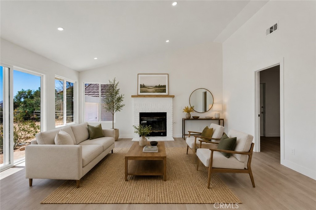 27679 River Rock Road Helendale, CA 92342 - Photo 29 of 65 a living room with furniture and a fireplace