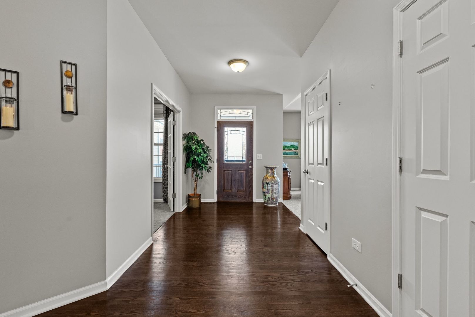 428 East Frontier Drive Minooka, IL 60447 - Photo 4 of 39 a view of a hallway with wooden floor and windows