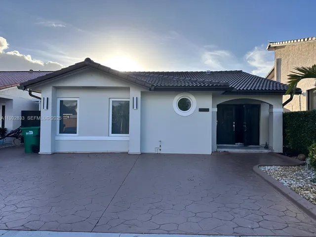 a view of a house with a yard and garage