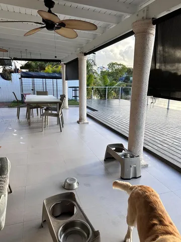 a view of a patio with table and chairs a barbeque
