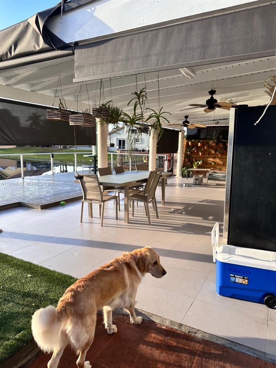 5855 Southwest 128th Court, Unit 5855 Miami, FL 33183 - Photo 10 of 12 a view of a patio with table and chairs a barbeque