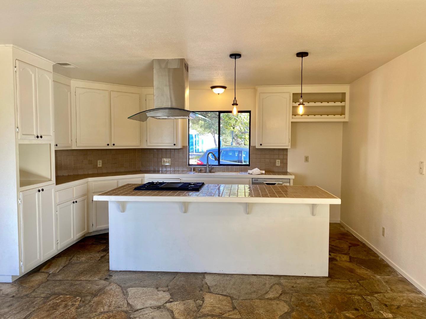 241 Webb Road Watsonville, CA 95076 - Photo 12 of 40 a kitchen with stainless steel appliances granite countertop a stove a sink and a refrigerator