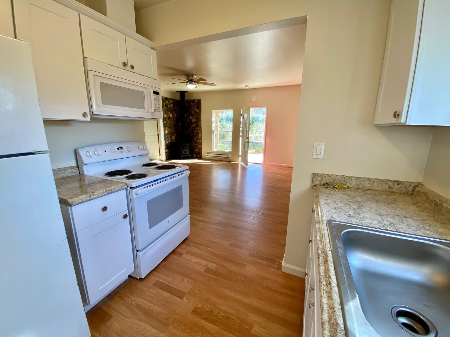 241 Webb Road Watsonville, CA 95076 - Photo 29 of 40 a kitchen with granite countertop a stove and cabinets