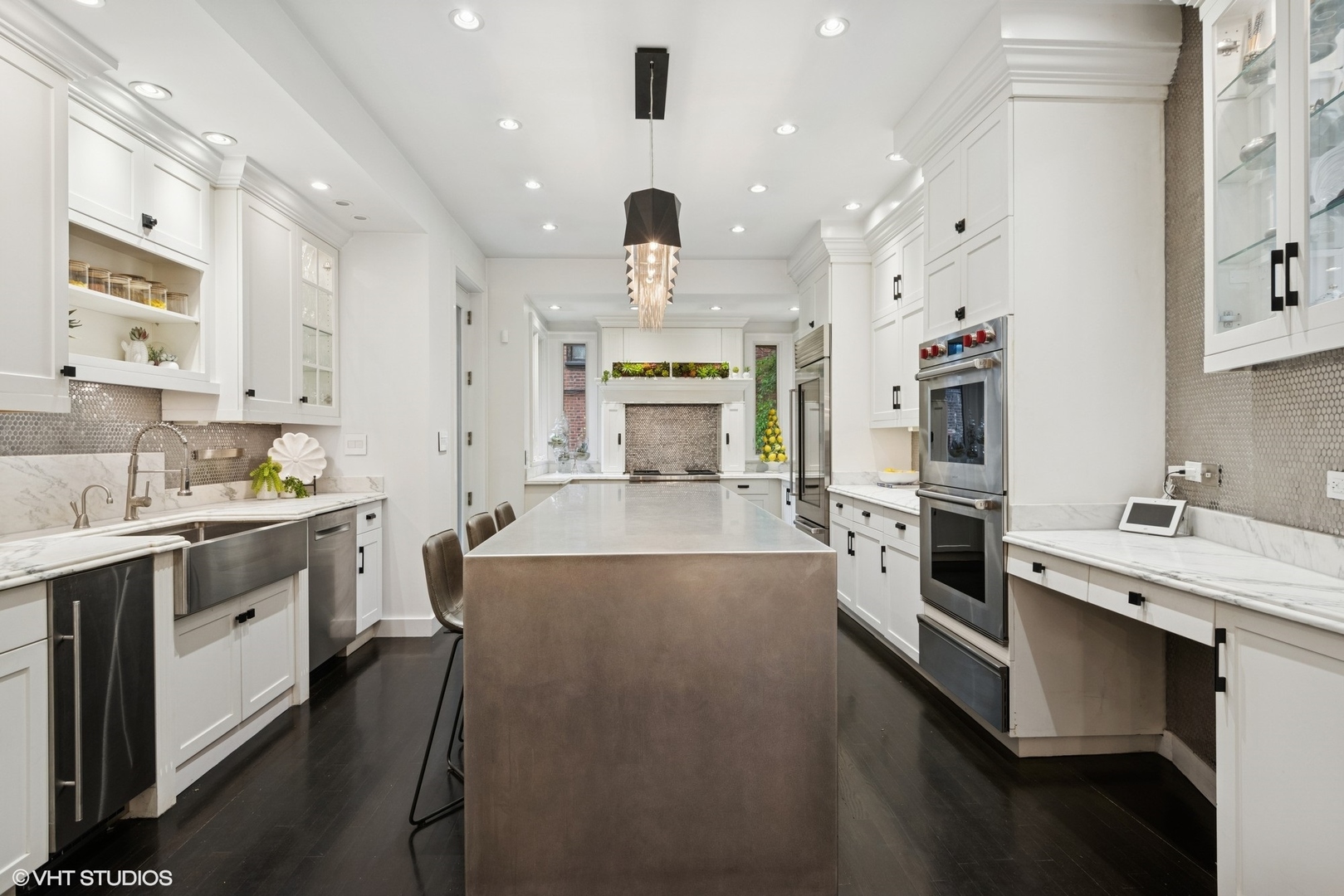 42 East Schiller Street Chicago, IL 60610 - Photo 12 of 50 a large kitchen with stainless steel appliances kitchen island granite countertop a large center island and a stove top oven