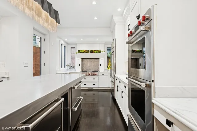 a kitchen with granite countertop a sink stove and cabinets