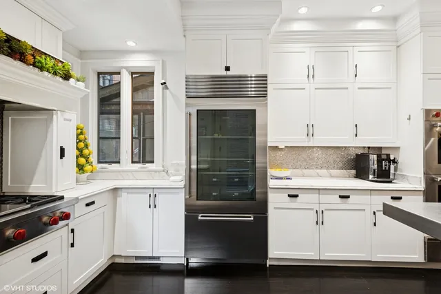 a kitchen with granite countertop white cabinets and appliances