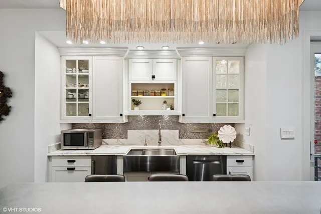 a kitchen with stainless steel appliances a stove a sink and a microwave