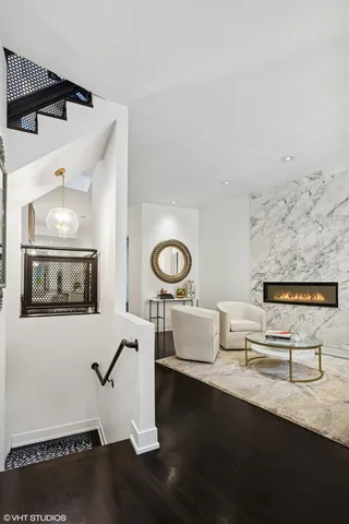 a living room with furniture and painting on the wall