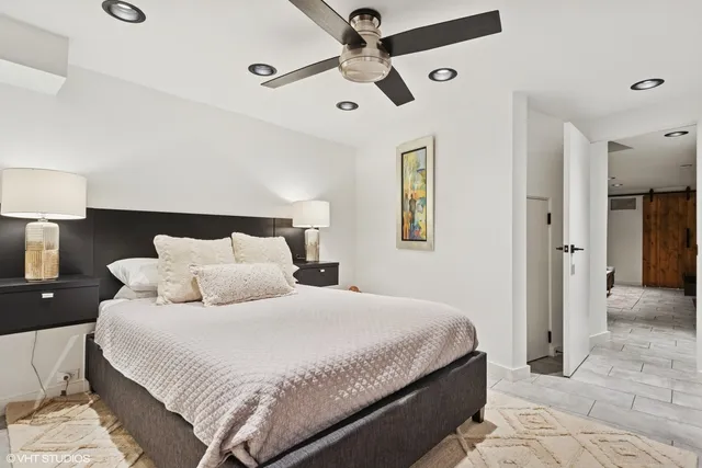 a bedroom with bed and a chandelier