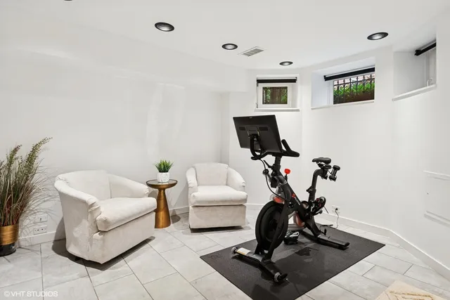 a living room with furniture a rug and white walls