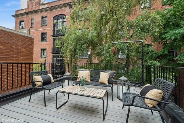a view of a patio with couple of chairs