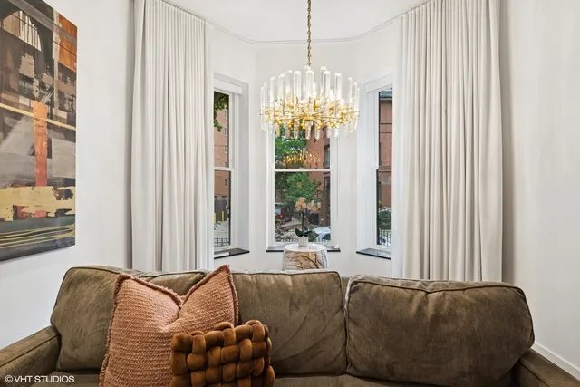 a living room with furniture and a chandelier