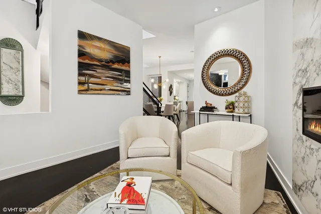 a living room with furniture and a mirror