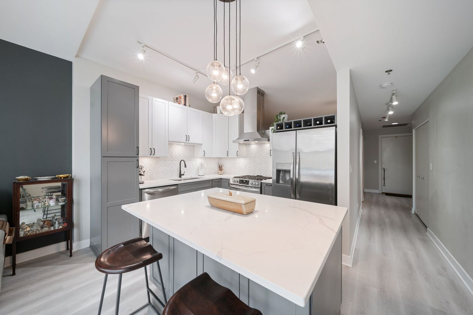 225 South Sangamon Street, Unit 308 Chicago, IL 60607 - Photo 11 of 34 a kitchen with kitchen island a stove a table and chairs in it