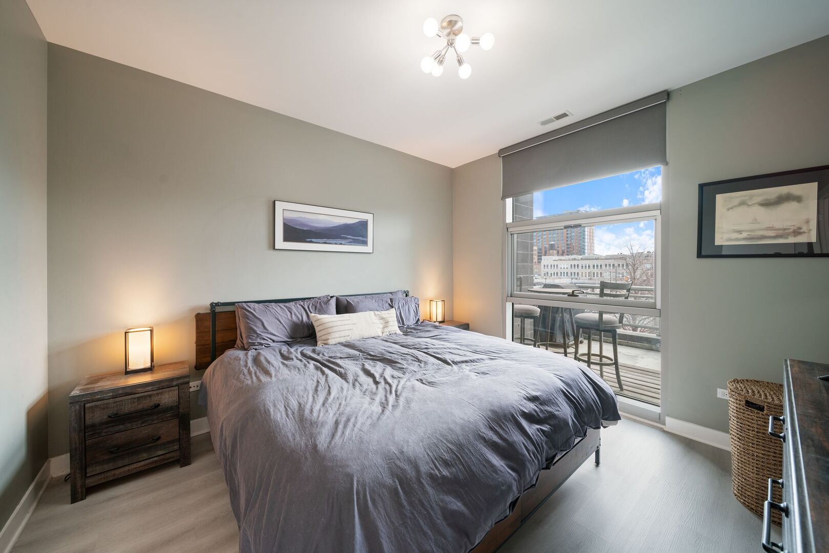 225 South Sangamon Street, Unit 308 Chicago, IL 60607 - Photo 13 of 34 a bedroom with a bed and a chandelier